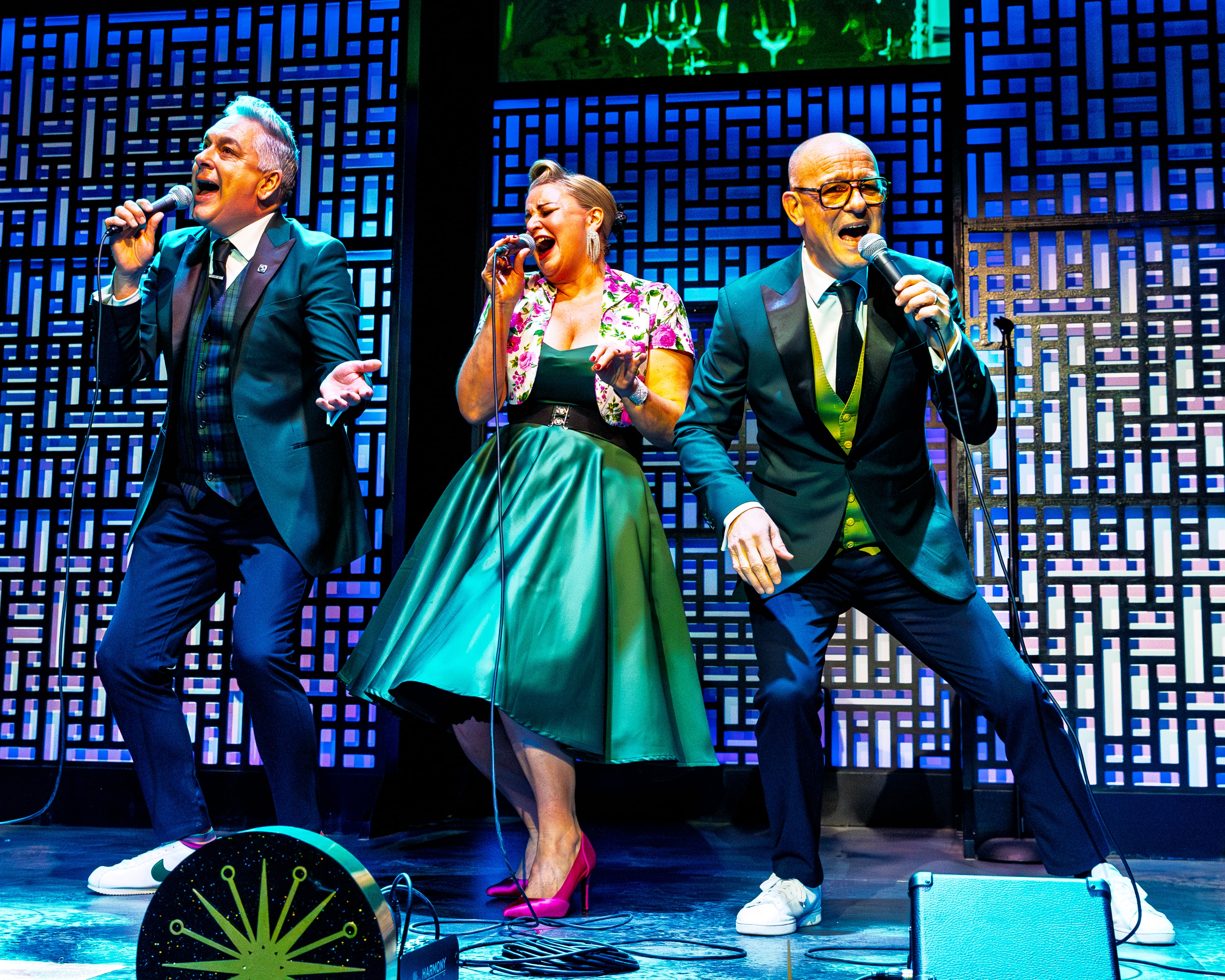 The Fabulous Lounge Swingers — trio singing passionately on stage