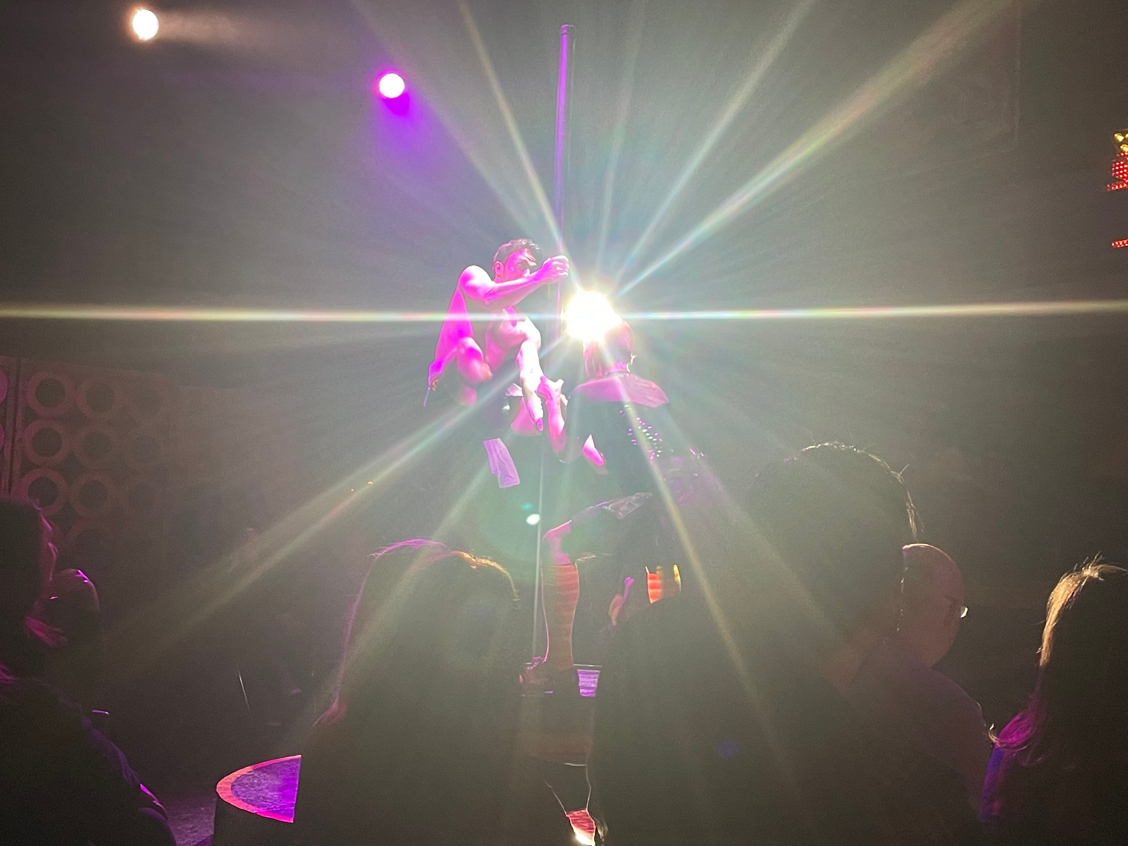 Saucy Jack and the Space Vixens 2022 — pole dancer performing on stage with lights