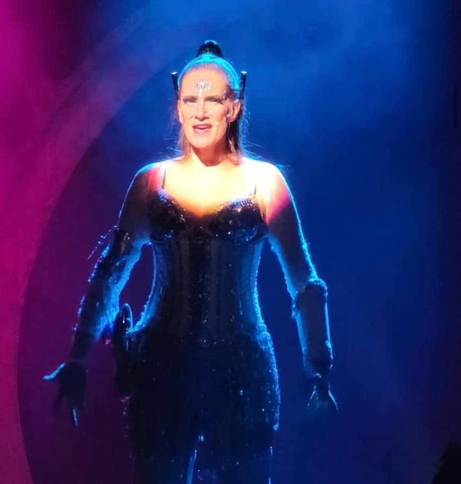 Saucy Jack and the Space Vixens 2022 — futuristic performer with glowing neon stage lights