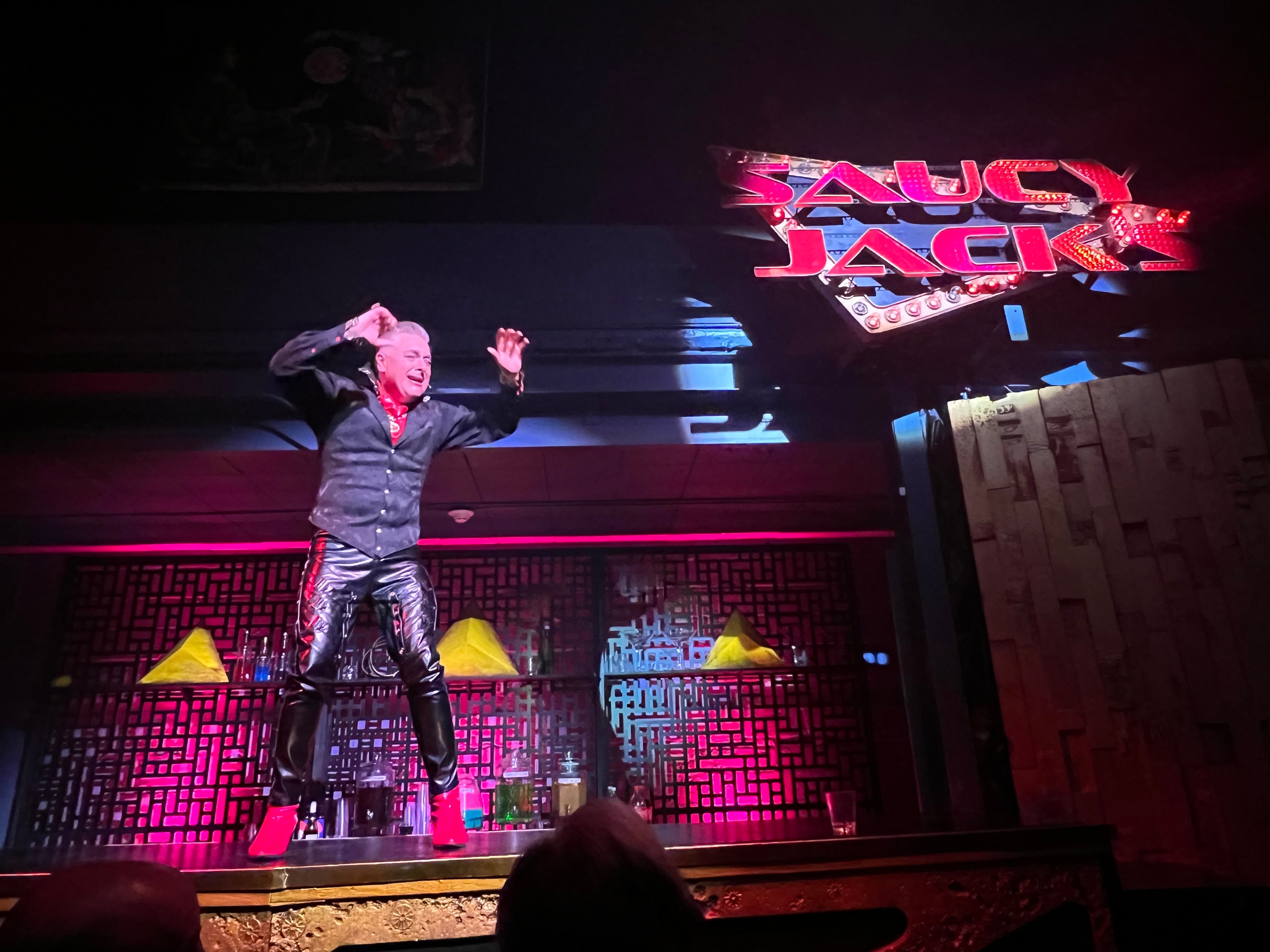 Saucy Jack and the Space Vixens 2022 — performer on stage with neon lights jumping